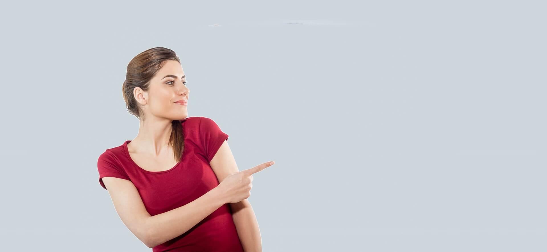 Isolated young woman is presenting or pointing with her finger